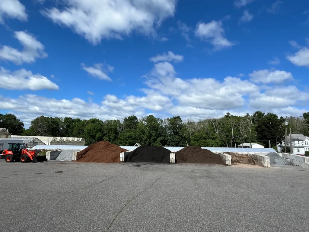 Outdoor landscape supply yard with material piles.